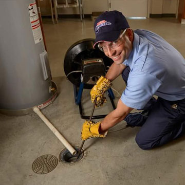 Roto-Rooter Plumbing & Drain Service technician unclogging a drain in a home in Lynchburg, VA